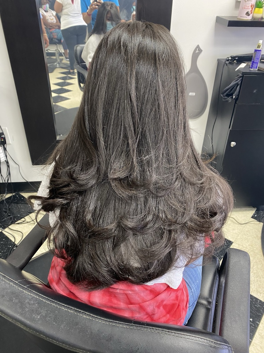 Long dark layered blowout inside Yokasta Dominican Hair Salon